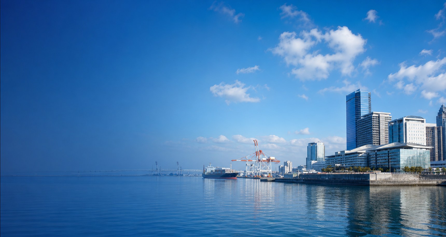 Modern Osaka bayside and international port under a clear blue sky